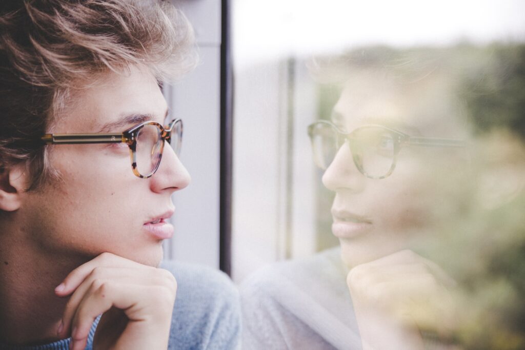 ELI Assessment: a man wearing glasses looking out a window